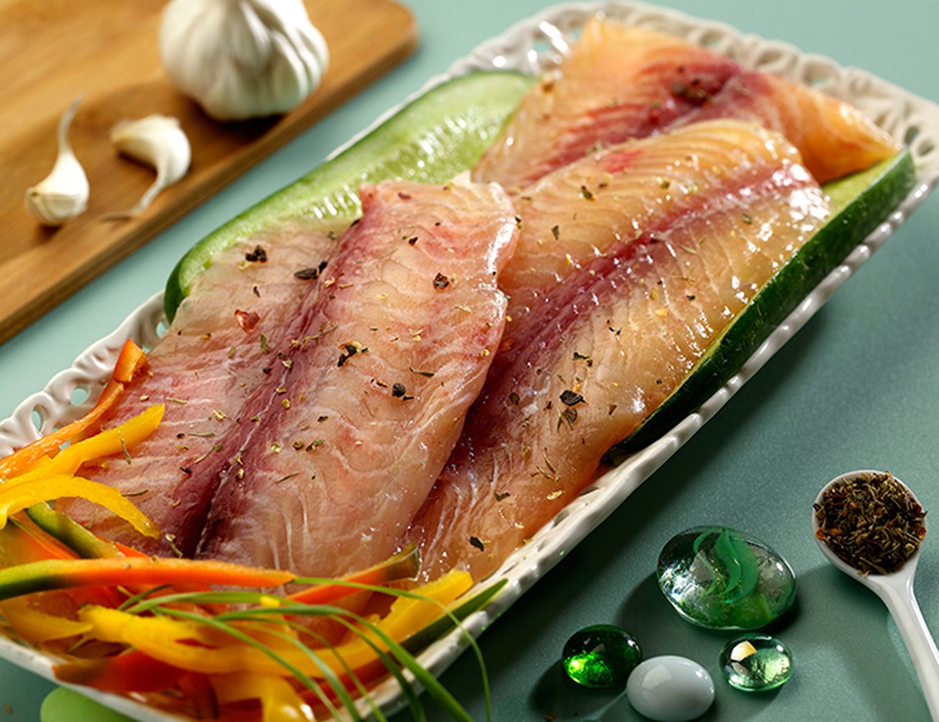 Fish-N-Fish boneless fillets plated with cucumber, peppers and herbs
